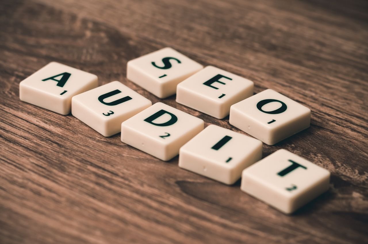 Crafting Captivating Headlines: Your awesome post title goes here Scrabble tiles spelling SEO Audit on wooden surface, symbolizing digital marketing strategies.